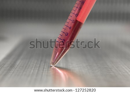 Test-tube with blood sample in bio lab under studio lights