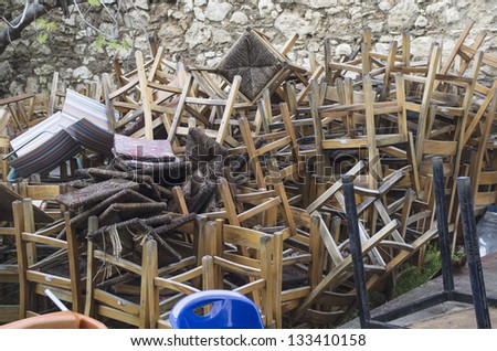 Old chairs on a pile under natural lights