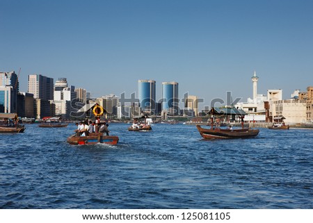 DUBAI CREEK, UAE - MAY 27 - Skyline view of Dubai Creek with traditional boat taxi activity. The creek is dividing the city into two main sections - Deira and Bur Dubai. Picture taken on May 27, 2010.