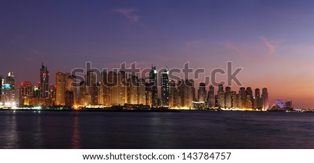 DUBAI, UAE - DEC 17: A night view of Dubai Marina including JBR - Jumeirah Beach Residence towers on Dec 17, 2010 in Dubai. This is the right side of a magnificent panorama seen from the Arabian Gulf