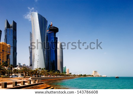 DOHA, QATAR - MAY 2: Tall buildings of the West Bay on May 2, 2013 in Doha, Qatar. The West Bay is rapidly expanding urban center of Doha with numerous skyscrapers gracing the skyline of the city