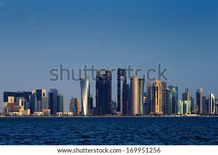 DOHA, QATAR - NOV 14: Iconic new towers grace the skyline of the West Bay area of Doha at dusk on Nov 14, 2013 in Doha, Qatar. The West Bay is considered as one of the most prominent districts of Doha