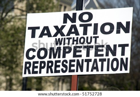 a sign at a tea party rally protesting USA tax laws