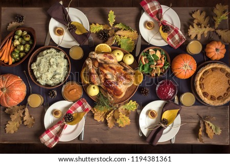 Thanksgiving Celebration Traditional Dinner Setting Food Concept. Thanksgiving Turkey with all sides on table, lots of seasonal festive food.
