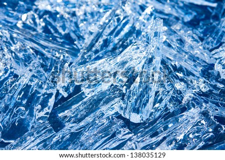 Ice crystals (peaces) sparkling blue texture close up, christmas winter horizontal background.