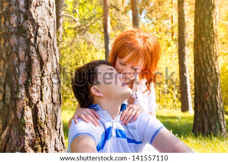 Outdoor beautiful sensual happy couple in love posing in spring, summer park, sunny weather. Young boy and girl having fun outdoor