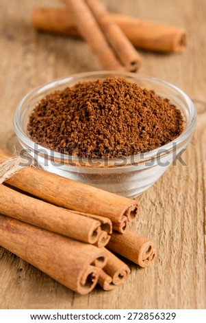 cinnamon sticks and powder vertical close up, selective focus