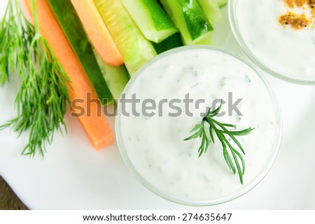 fresh Greek Tzatziki yogurt dip (sauce) and assorted vegetables on white plate