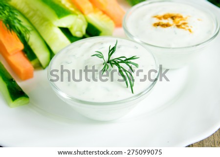 fresh Greek Tzatziki yogurt dip (sauce) and assorted vegetables on white plate