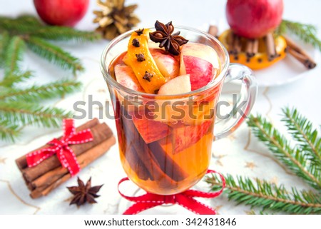 Spicy hot drink (cider, punch, tea) with apple, orange, cinnamon, star anise for Christmas and winter holidays