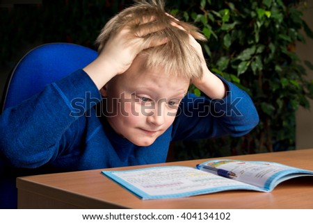 Tired boring boy don\'t want to do his difficult school homework