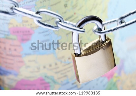 Closeup of padlock on world map representing global security concept