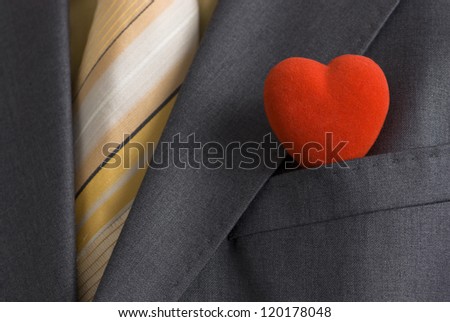 A red heart in a suit pocket representing the business card of modern Mr. Valentine.
