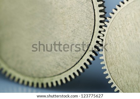 Partnership.Close-up of two steel gears linked concept for teamwork and partnership