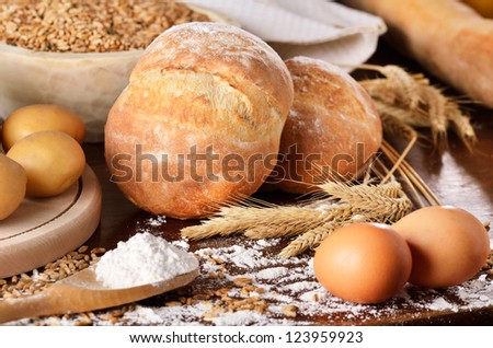 Rural scene of homemade bread with potatoes and eggs. Landscape view.