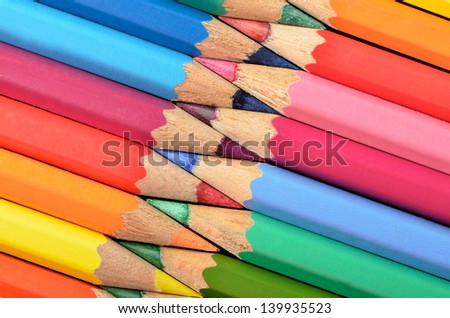 Rainbow colors with pencils arranged in the shape of a zipper