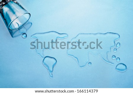 Glass of water spilled into shape of world map