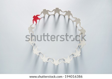 Circle of white business men paper cut-out figures with red leader standing out from the crowd