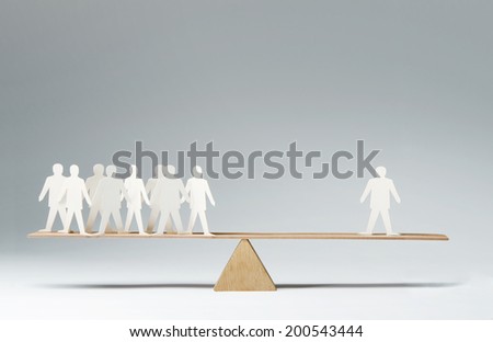 Men balanced on seesaw over a single man