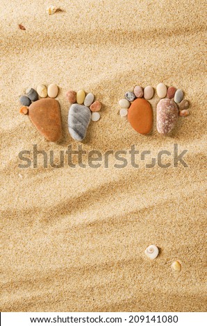 Happy feet. Stone arranged like a footprint on the beach