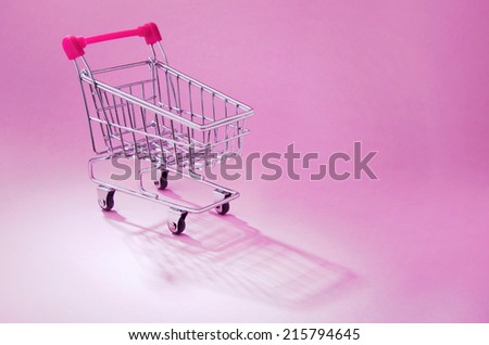 A shopping cart on pink background