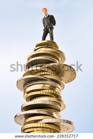 Business figurine on top of invested money