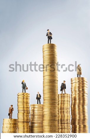 Business figurines on top of invested money