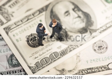 Two businessmen on US paper currency