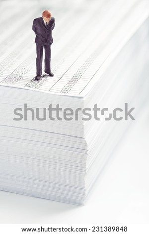 Businessman standing on top of office paper