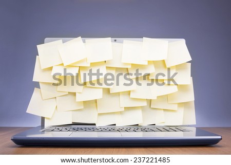 Colored post-it notes covering laptop screen