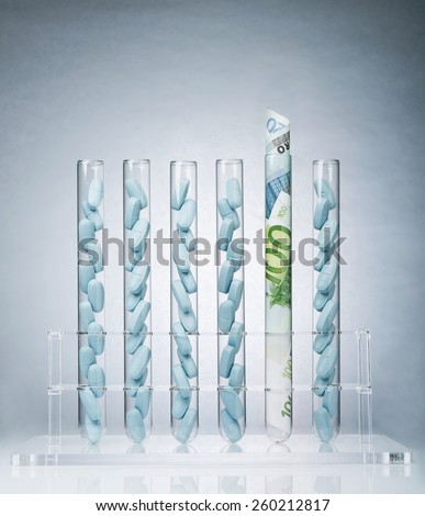 Rolled up US paper banknote in a test tube rack representing the costs of medical research