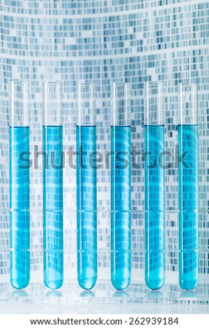 Laboratory sample test tubes with DNA gel in background