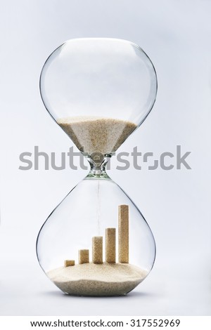 Business growth graphic bar made out of falling sand inside hourglass