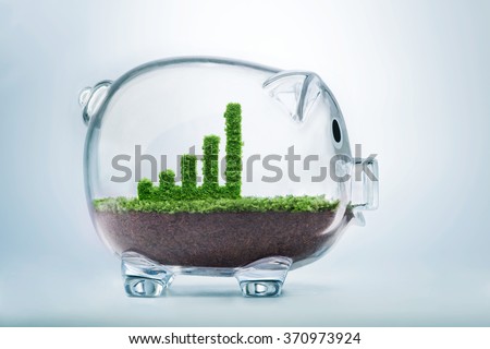 Business growth concept with grass growing in shape of graphic bar inside transparent piggy bank