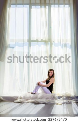 Model near the window. Beauty and fashion shot.