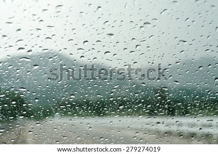 raindrops on auto glass with mountain view