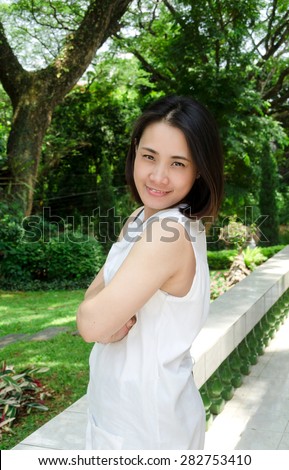 portrait of asia women in green nature garden, Thai women smile for the camera