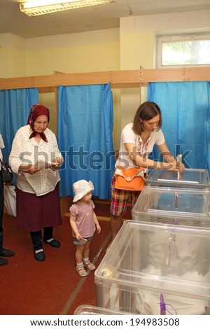 Kiev, Ukraine - May 25, 2014: Election of the President of Ukraine and Kiev measure. Voters cast their bulletins to the basket for a vote.