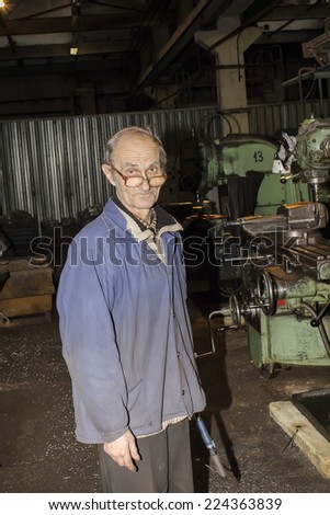 Kharkov, UKRAINE - 7 November 2013: Kharkiv Tractor Plant. in the production of the employee performs his work