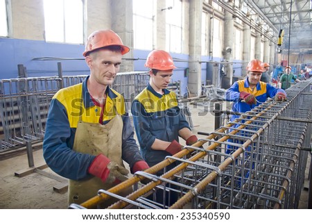 KIEV, UKRAINE - May 17 2013: The territory of the of the concrete plant. The workers form the metallic skeleton for pouring concrete