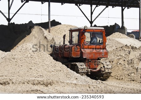 KIEV, UKRAINE - May 17 2013: The territory of the of the concrete plant. Bulldozer is gaining sand