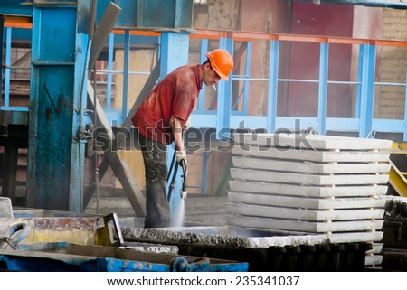 KIEV, UKRAINE - 17 May 2013: the territory of of the concrete plant. The workers at the workplace are busy with their duties of