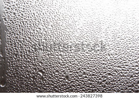 Misted window glass in drops of water