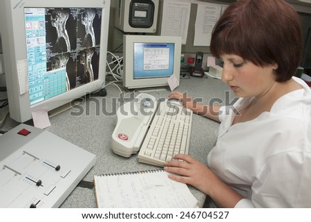 Khmelnik, UKRAINE - 20 May 2011: Experienced doctor with an MRI scan of the cervical portion on Monitor