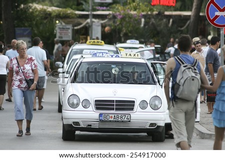 Budva, MONTENEGRO - 22 July 2011:white taxis waiting for passengers. Budva among the oldest urban settlements of the Adriatic coast.