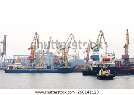 Odessa, Ukraine - October 22, 2011: Commercial Port of Ilyichevsk. The loading of a cargo ship at dock in Odessa seaport. Mechanized metal work truck
