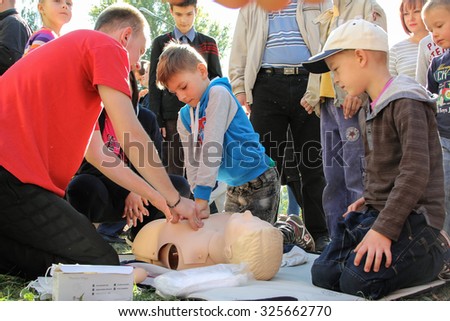 Kiev, Ukraine - October 04, 2015: Emergency rescue service. Rescuer explains of a teenager first aid to