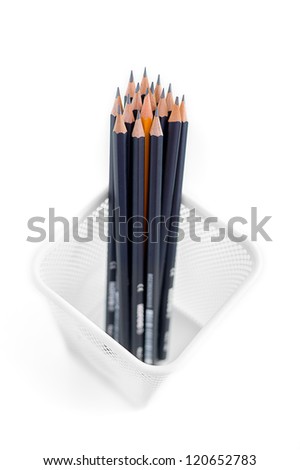 Black graphite pencils and yellow one in the metallic meshy box on white isolated background