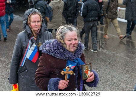 MOSCOW, RUSSIA - MARCH 2: Old woman with orthodox icon on rally in support of U.S. adoption ban. Moscow, March 2, 2013