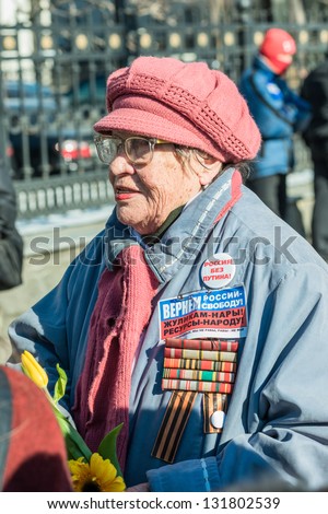 MOSCOW, RUSSIA - 8 MARCH: Elder russian woman activist with signs reads \'Russia without Putin\' and \'Let us return back freedom to Russia!\'. Picket to free Pussy Riot members on March 8, 2013 in Moscow